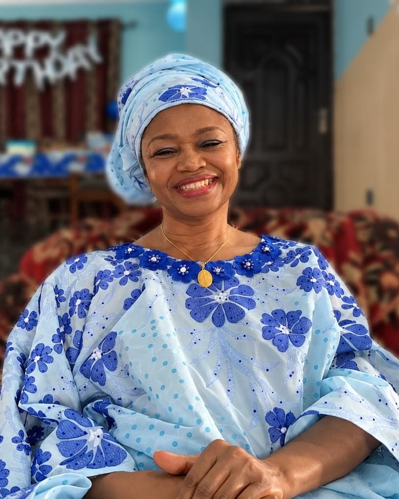 Mrs Egbo smiling in a blue floral gown at a family birthday celebration